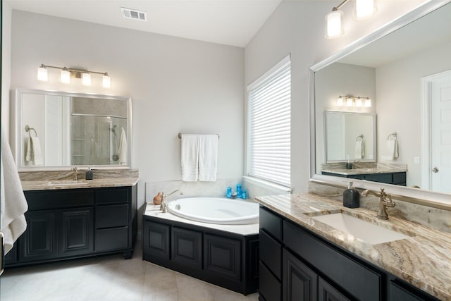 bathroom featuring a bath, a stall shower, a sink, and visible vents