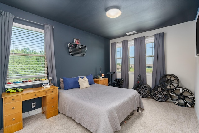 bedroom with carpet, multiple windows, and visible vents