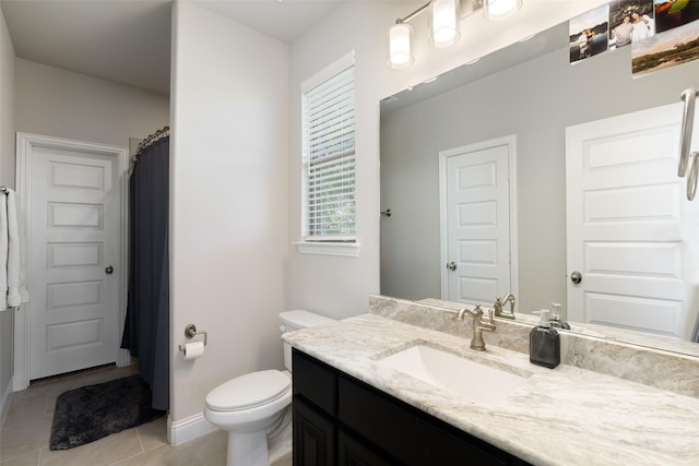 bathroom featuring curtained shower, toilet, vanity, baseboards, and tile patterned floors