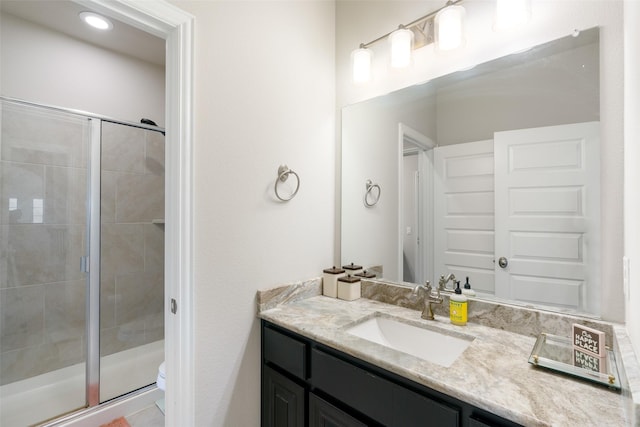 full bathroom with vanity, a shower stall, and toilet