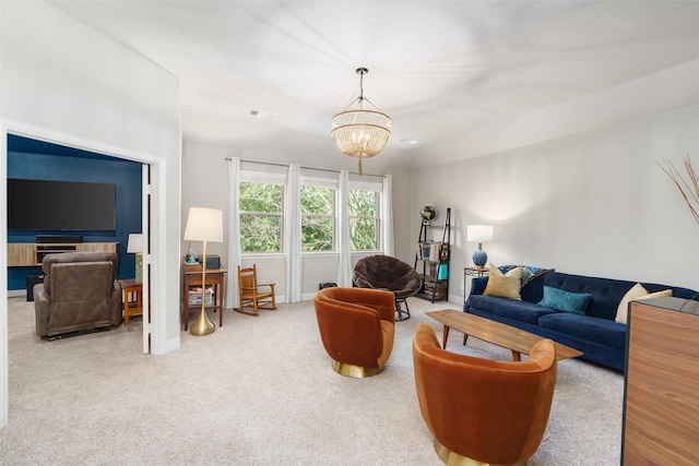 living room with carpet, visible vents, a chandelier, and baseboards