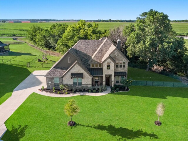 view of front of property with a front yard and a rural view