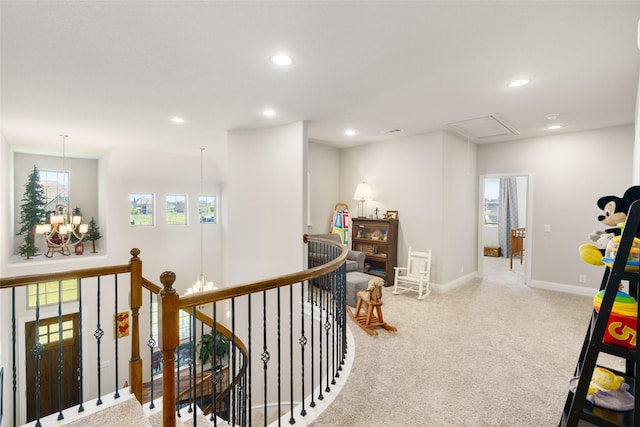 hall with carpet floors, recessed lighting, a chandelier, and an upstairs landing