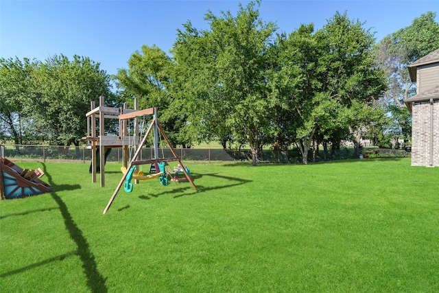 view of play area with a lawn and fence