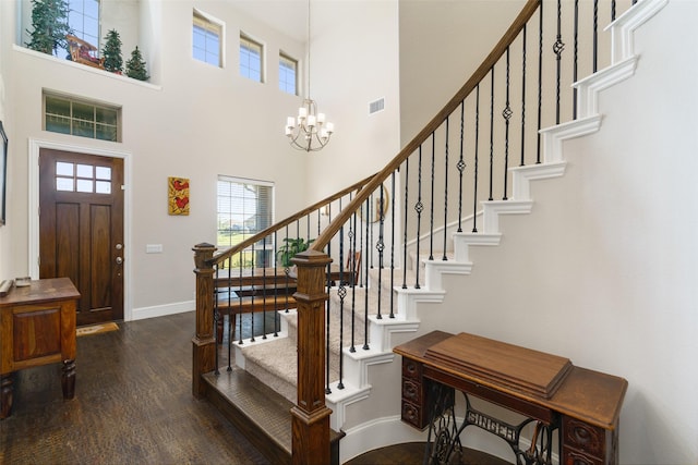 entryway featuring dark wood-style floors, visible vents, stairway, an inviting chandelier, and baseboards