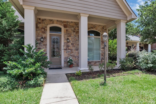 doorway to property with a lawn