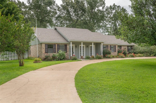 ranch-style home featuring a porch and a front yard