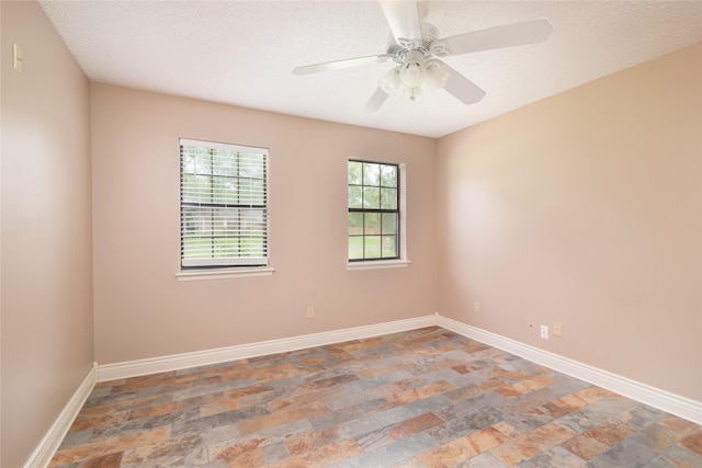 empty room featuring a textured ceiling and ceiling fan