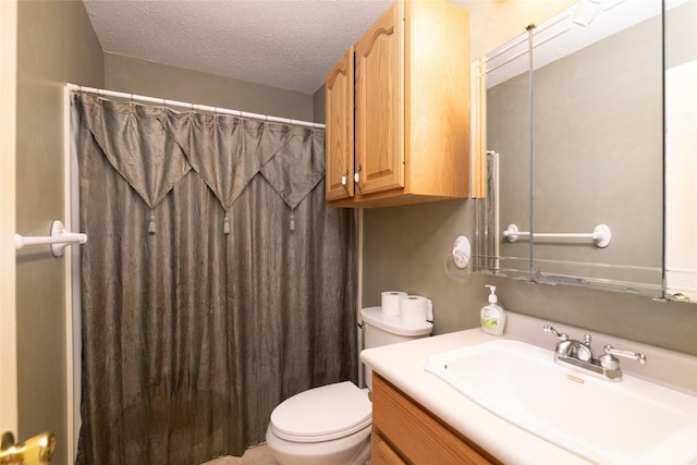 bathroom featuring vanity, a shower with curtain, a textured ceiling, and toilet