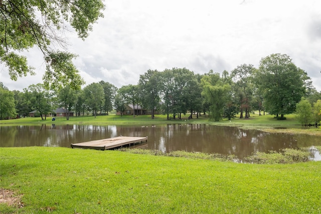 exterior space featuring a yard and a water view