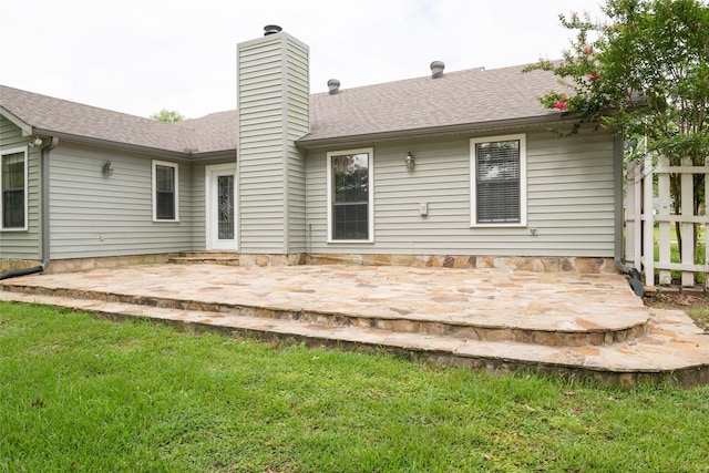 rear view of property featuring a yard and a patio