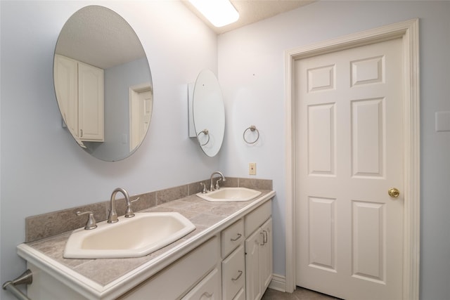 bathroom with vanity and a textured ceiling