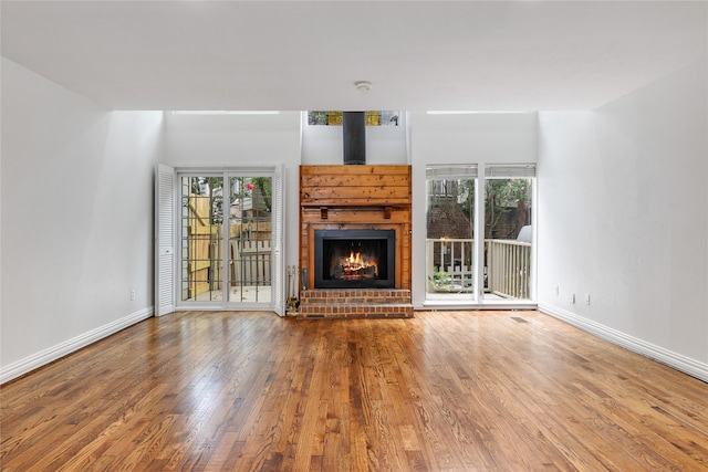 unfurnished living room featuring a fireplace and hardwood / wood-style flooring