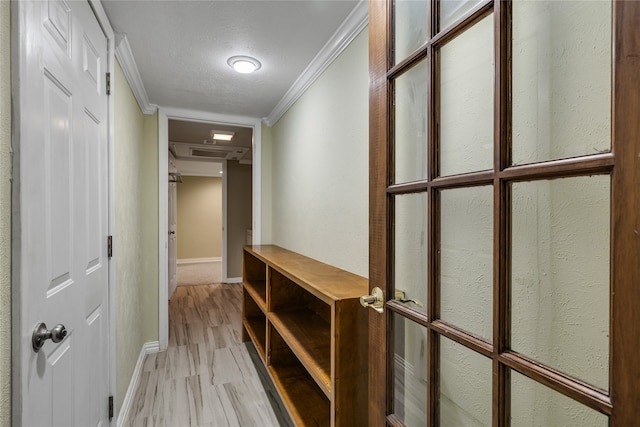 hallway featuring a textured ceiling, crown molding, and light hardwood / wood-style flooring