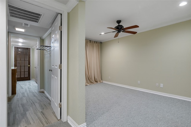 corridor featuring light colored carpet and ornamental molding