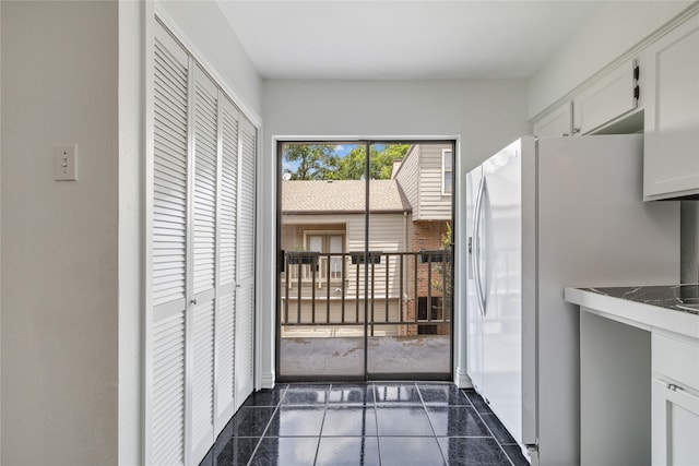 entryway featuring dark tile patterned flooring