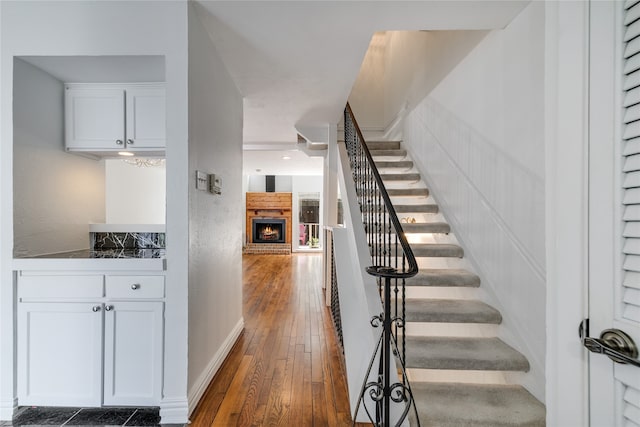 staircase with wood-type flooring