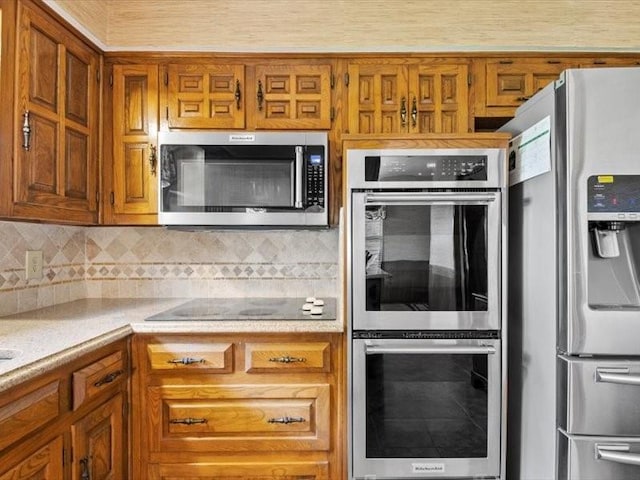 kitchen featuring appliances with stainless steel finishes and backsplash