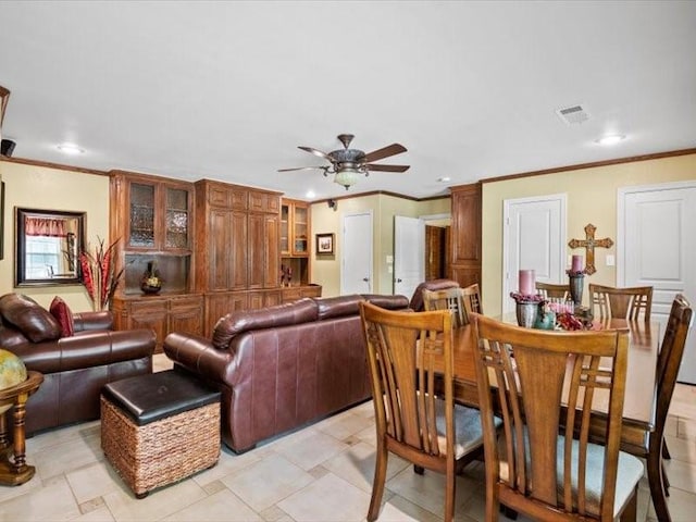 living room featuring ceiling fan and ornamental molding