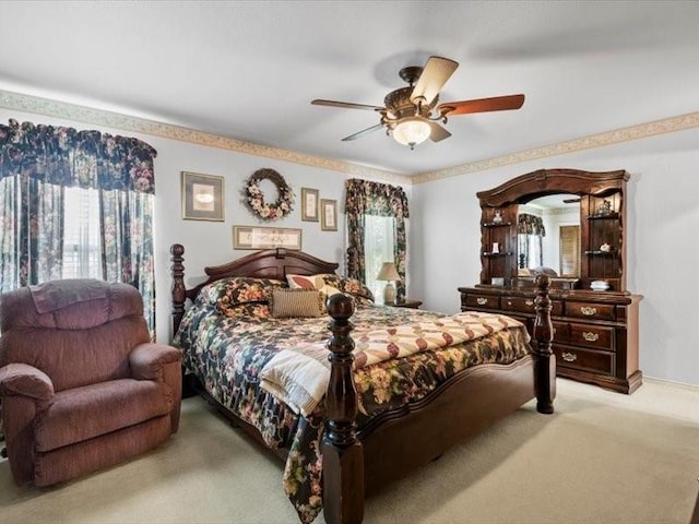 bedroom with ceiling fan and light carpet