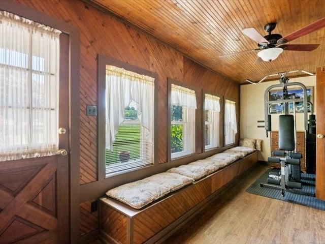 sunroom / solarium featuring ceiling fan and wooden ceiling