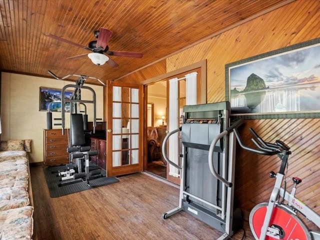 exercise room with ceiling fan, french doors, hardwood / wood-style floors, wooden walls, and wood ceiling