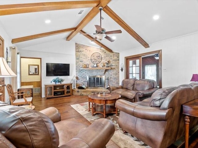 living room with hardwood / wood-style floors, lofted ceiling with beams, ceiling fan, and a fireplace