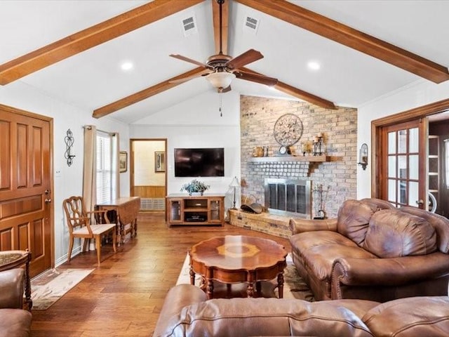 living room with a fireplace, hardwood / wood-style floors, lofted ceiling with beams, and ceiling fan