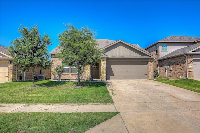 view of front of property with central AC unit, a garage, and a front lawn