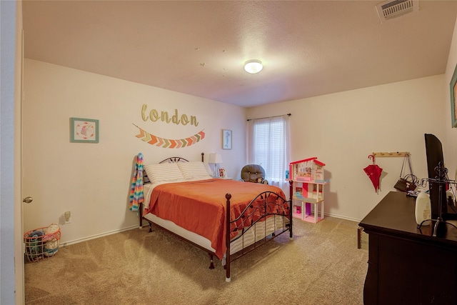 carpeted bedroom featuring a textured ceiling