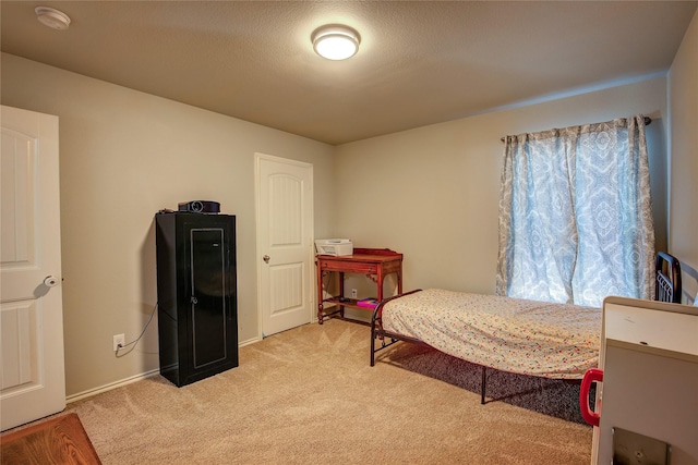 carpeted bedroom featuring a textured ceiling