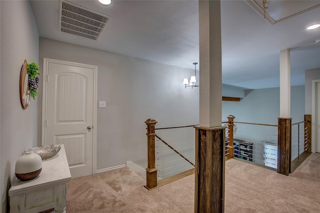 hallway featuring light colored carpet