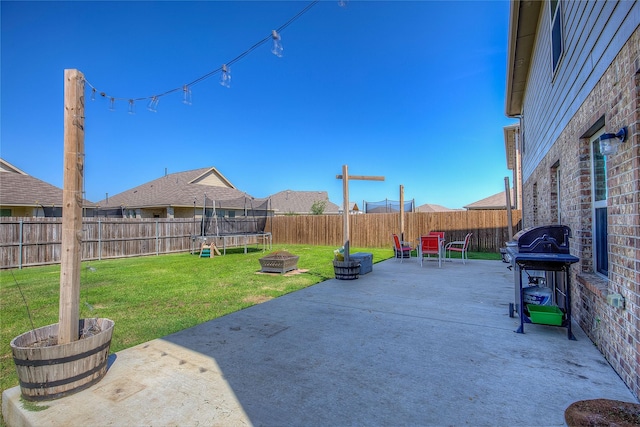 view of patio with grilling area and a trampoline