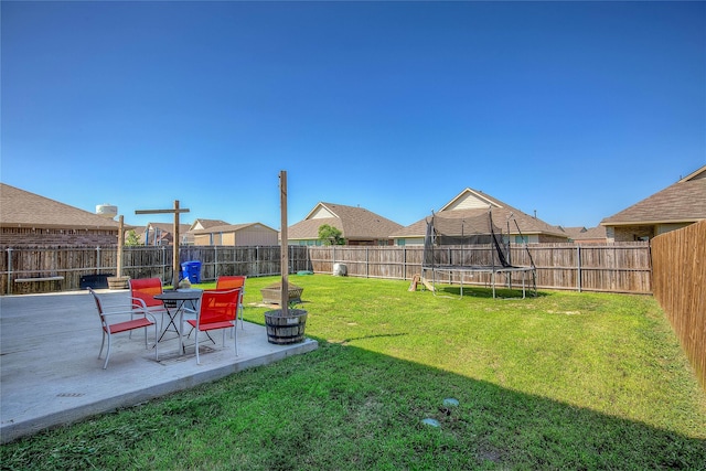 view of yard featuring a patio area and a trampoline