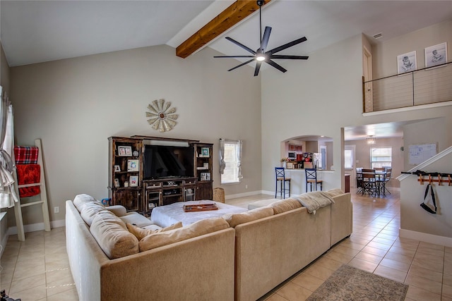 living room featuring beamed ceiling, light tile patterned floors, high vaulted ceiling, and ceiling fan