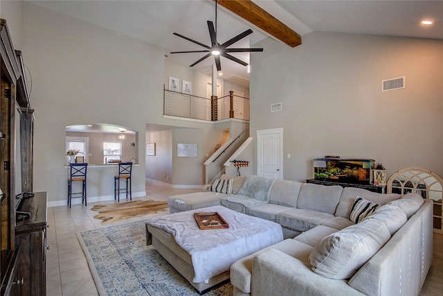 tiled living room with beam ceiling, high vaulted ceiling, and ceiling fan