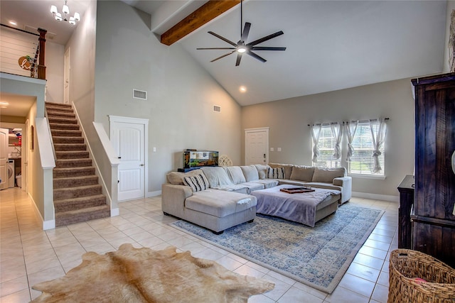 tiled living room featuring ceiling fan with notable chandelier, beam ceiling, washer / clothes dryer, and high vaulted ceiling