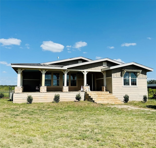 back of house featuring a yard and board and batten siding