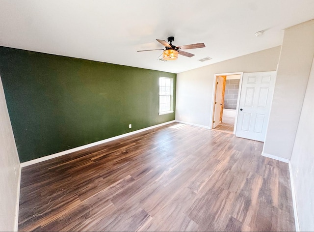 unfurnished room with baseboards, wood finished floors, visible vents, and ceiling fan