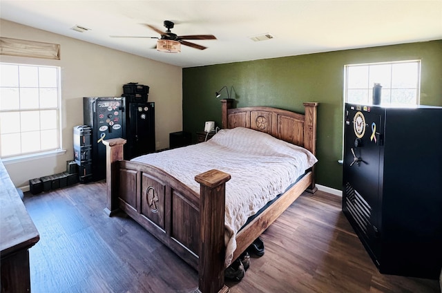 bedroom featuring ceiling fan and dark wood-type flooring