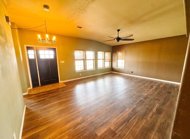 entryway featuring ceiling fan with notable chandelier, wood finished floors, baseboards, and a wealth of natural light