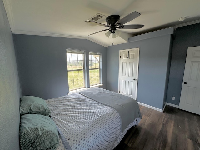 bedroom with wood finished floors, baseboards, visible vents, ornamental molding, and vaulted ceiling