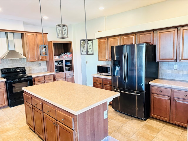 kitchen featuring wall chimney range hood, hanging light fixtures, tasteful backsplash, a kitchen island, and stainless steel appliances