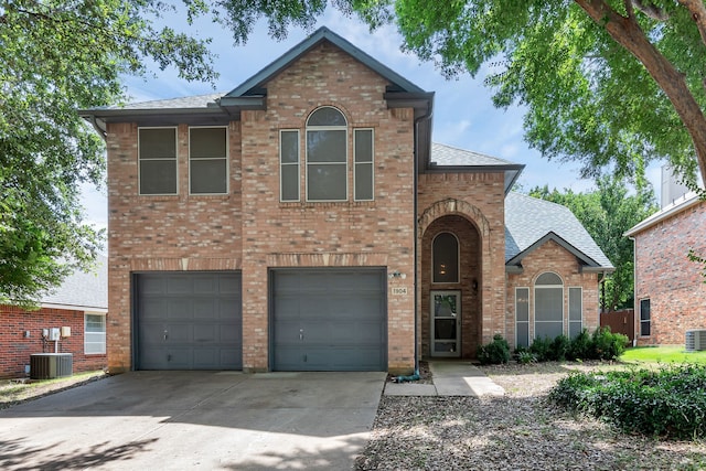 view of front of property featuring a garage and central air condition unit