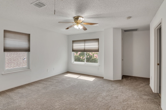 unfurnished bedroom featuring carpet, ceiling fan, and a textured ceiling