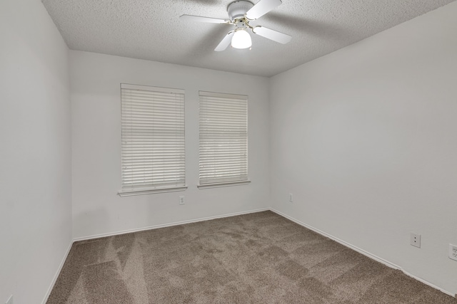 carpeted empty room with ceiling fan and a textured ceiling