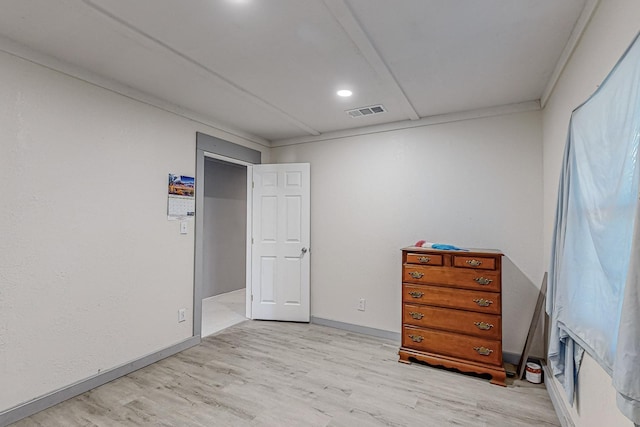 bedroom with crown molding and light hardwood / wood-style flooring