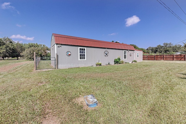 view of side of home with a lawn