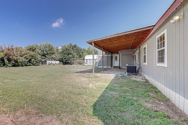 view of yard featuring central AC and a shed