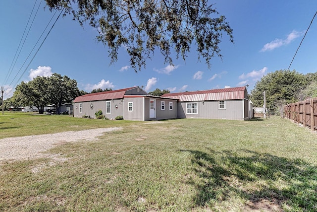 rear view of property with a lawn